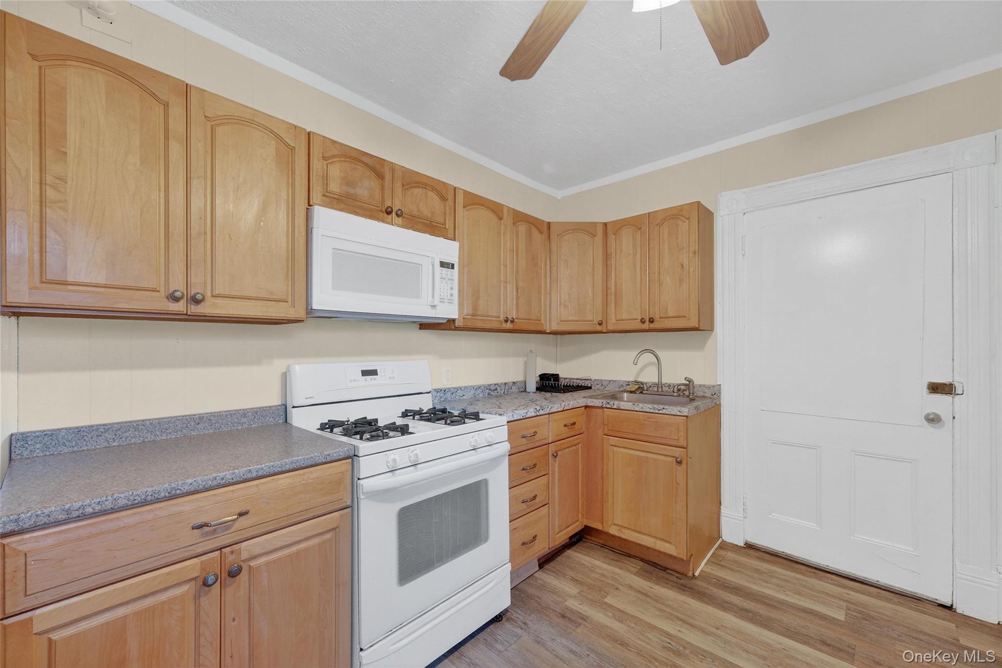 11 Zimmer Avenue, Unit 2 Poughkeepsie, NY 12601 - Photo 14 of 27 a kitchen with granite countertop white cabinets and white appliances