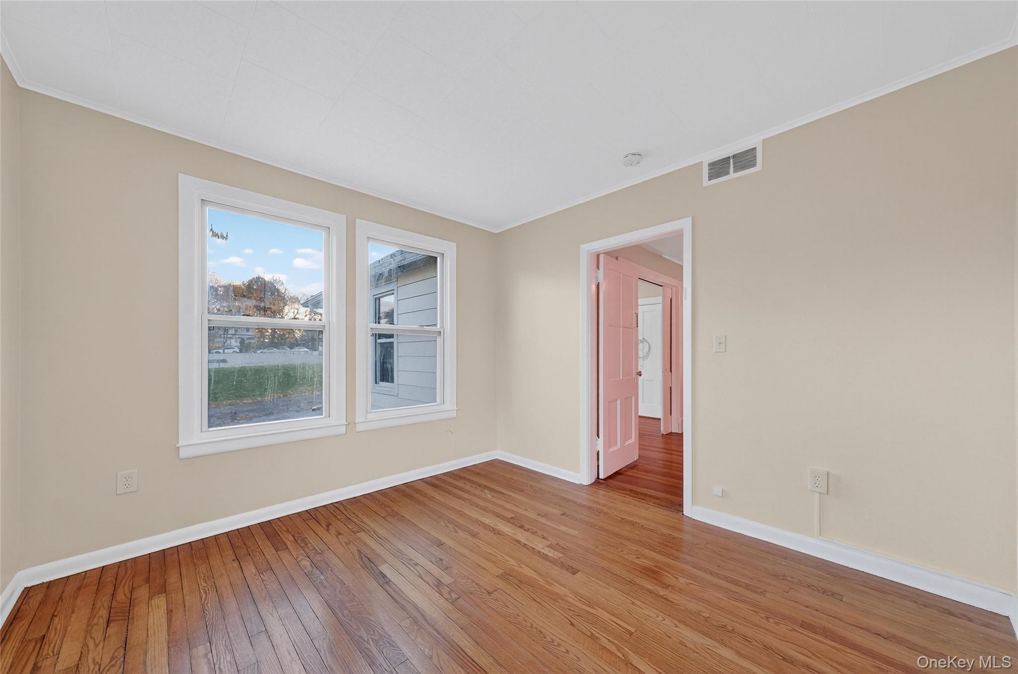 11 Zimmer Avenue, Unit 2 Poughkeepsie, NY 12601 - Photo 20 of 27 a view of an empty room with wooden floor and a window