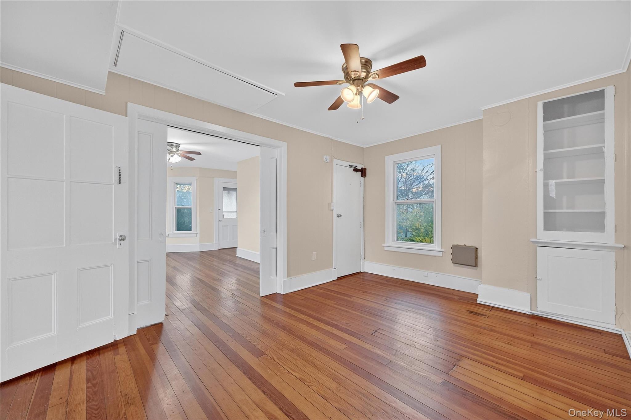 11 Zimmer Avenue, Unit 2 Poughkeepsie, NY 12601 - Photo 7 of 27 a view of an empty room with wooden floor and a window