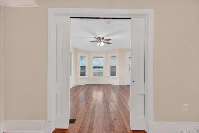 a view of an entryway with wooden floor