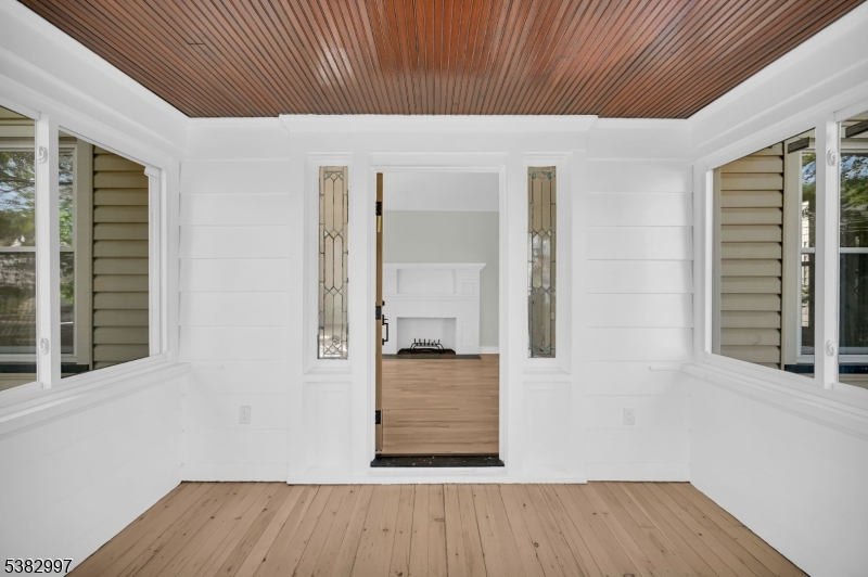 195 Sylvan Street Rutherford, NJ 07070 - Photo 12 of 50 a view of an empty room with wooden floor and a window