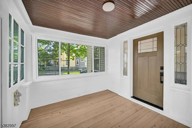 a view of empty room with wooden floor and fireplace