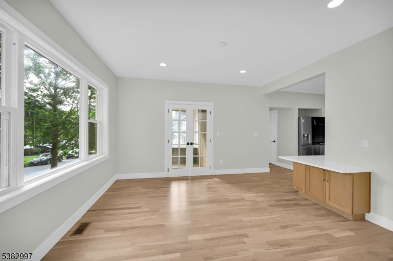 195 Sylvan Street Rutherford, NJ 07070 - Photo 18 of 50 a view of an empty room with wooden floor and a window