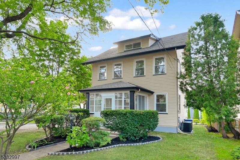 195 Sylvan Street Rutherford, NJ 07070 - Photo 20 of 50 a front view of a house with a yard and potted plants