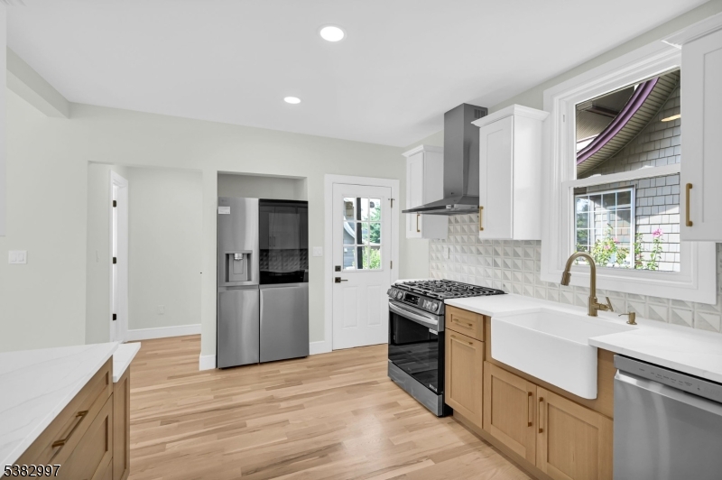 195 Sylvan Street Rutherford, NJ 07070 - Photo 2 of 50 a kitchen with a sink stove and refrigerator