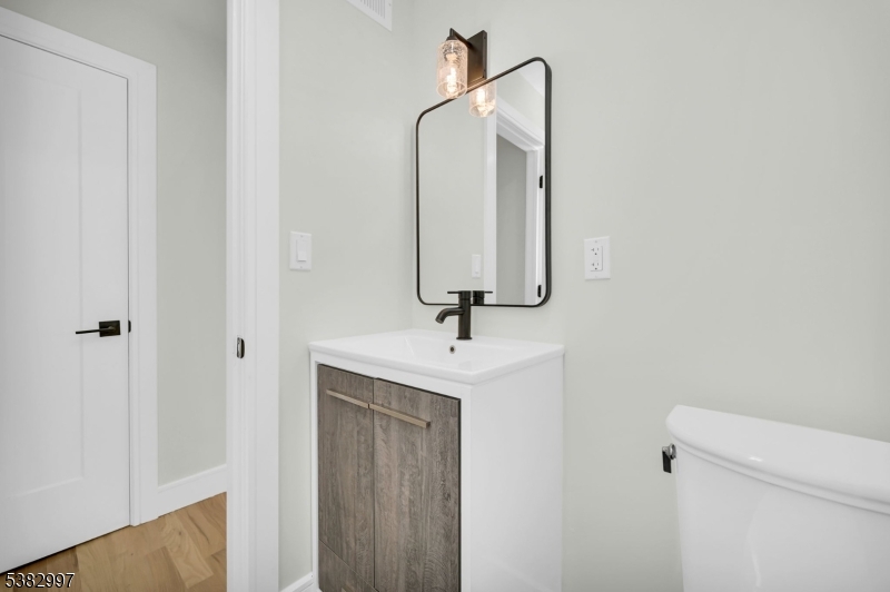 195 Sylvan Street Rutherford, NJ 07070 - Photo 26 of 50 a bathroom with a sink and a mirror