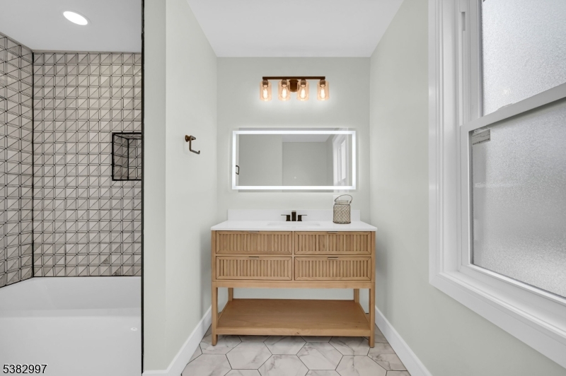 195 Sylvan Street Rutherford, NJ 07070 - Photo 34 of 50 a bathroom with a tub sink and mirror
