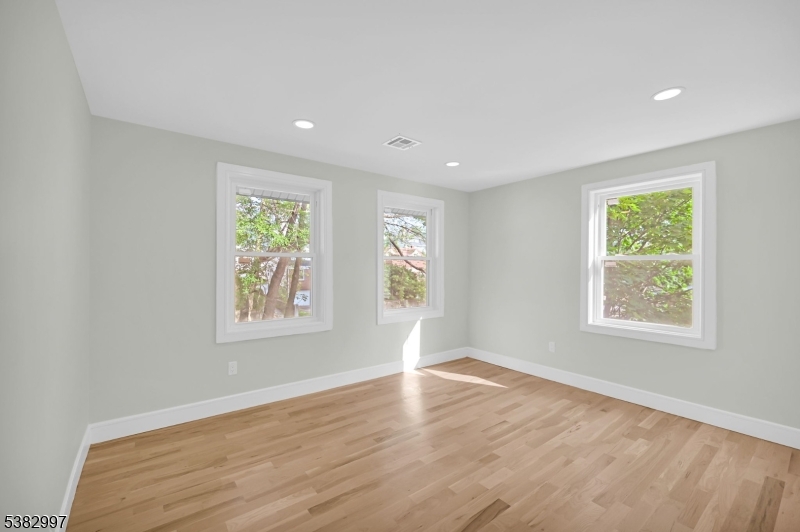 195 Sylvan Street Rutherford, NJ 07070 - Photo 35 of 50 an empty room with wooden floor and windows