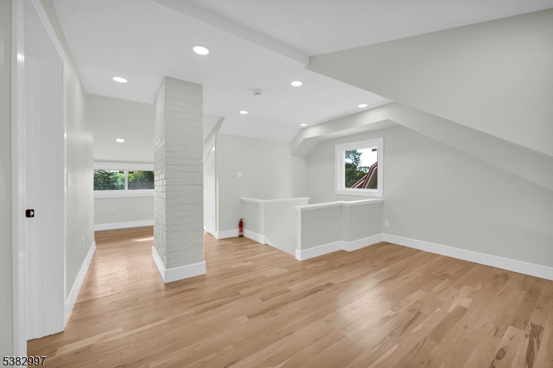 195 Sylvan Street Rutherford, NJ 07070 - Photo 37 of 50 an empty room with wooden floor and windows