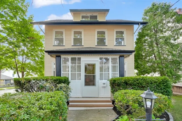 a view of a house with a yard and plants