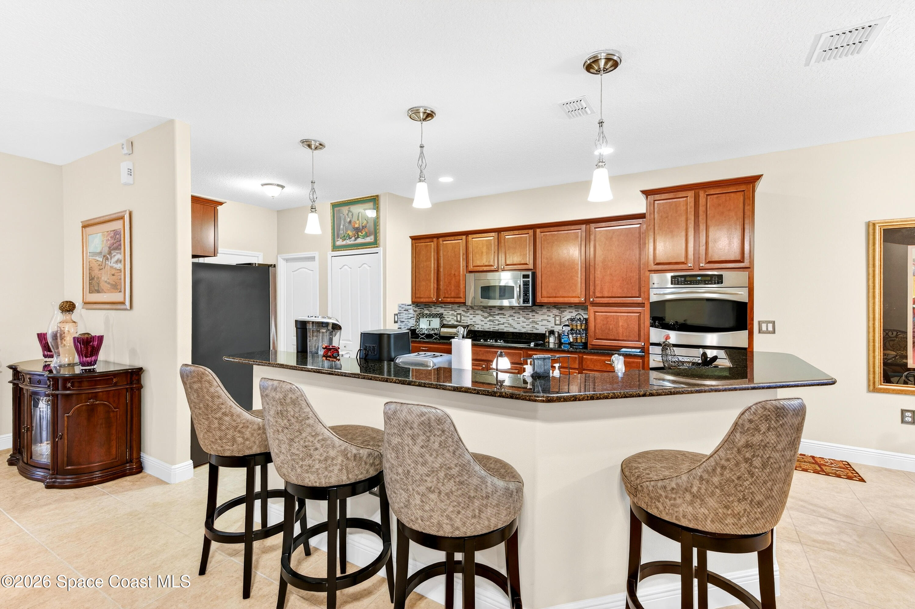 3347 Slate Street Melbourne, FL 32904 - Photo 18 of 48 Cabinetry w/Crown/Pendant Lights