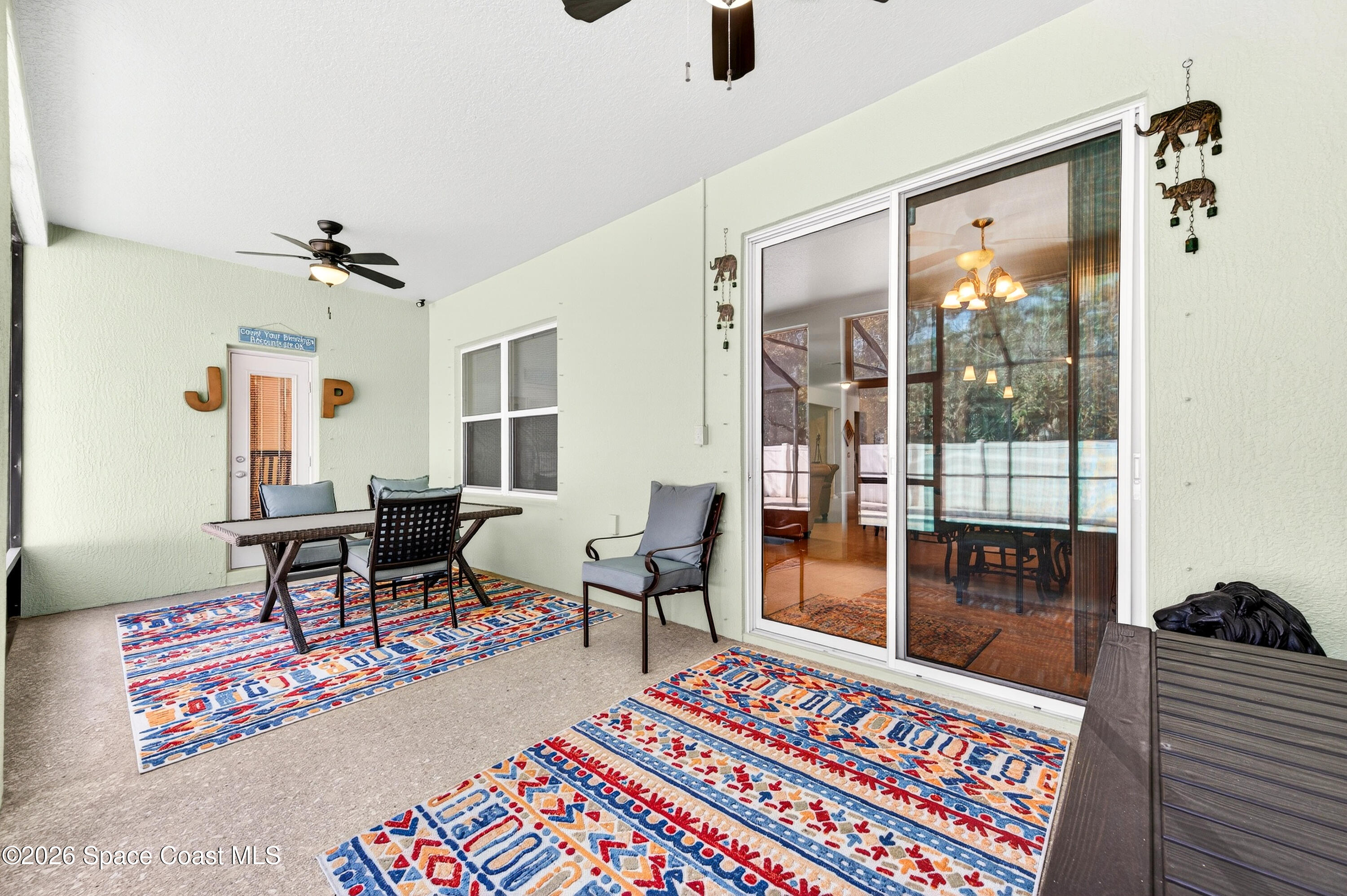 3347 Slate Street Melbourne, FL 32904 - Photo 35 of 48 Pool Bath Door & Sliders to Family Rm