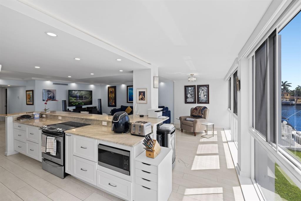 3100 Northeast 49th Street, Unit 206 Fort Lauderdale, FL 33308 - Photo 11 of 39 a kitchen with stove and cabinets