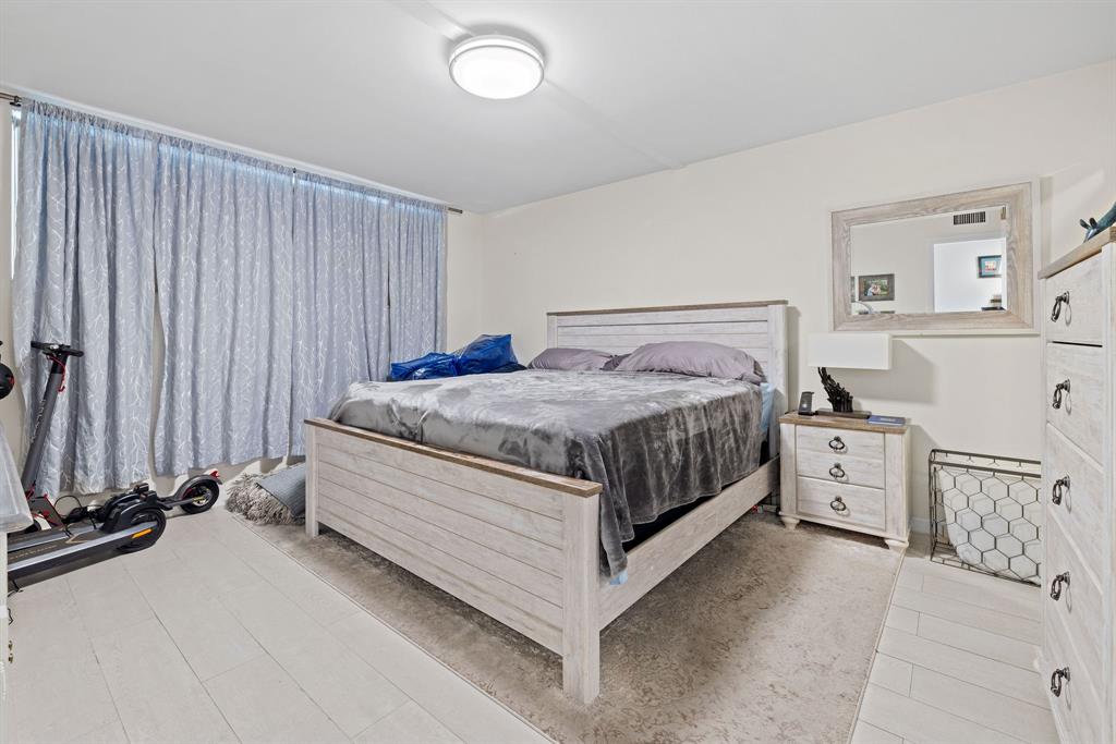 3100 Northeast 49th Street, Unit 206 Fort Lauderdale, FL 33308 - Photo 15 of 39 a bed room with a bed and a view of bedroom