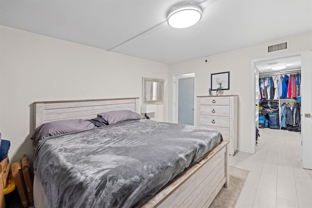 3100 Northeast 49th Street, Unit 206 Fort Lauderdale, FL 33308 - Photo 17 of 39 a bedroom with a bed and a mirror