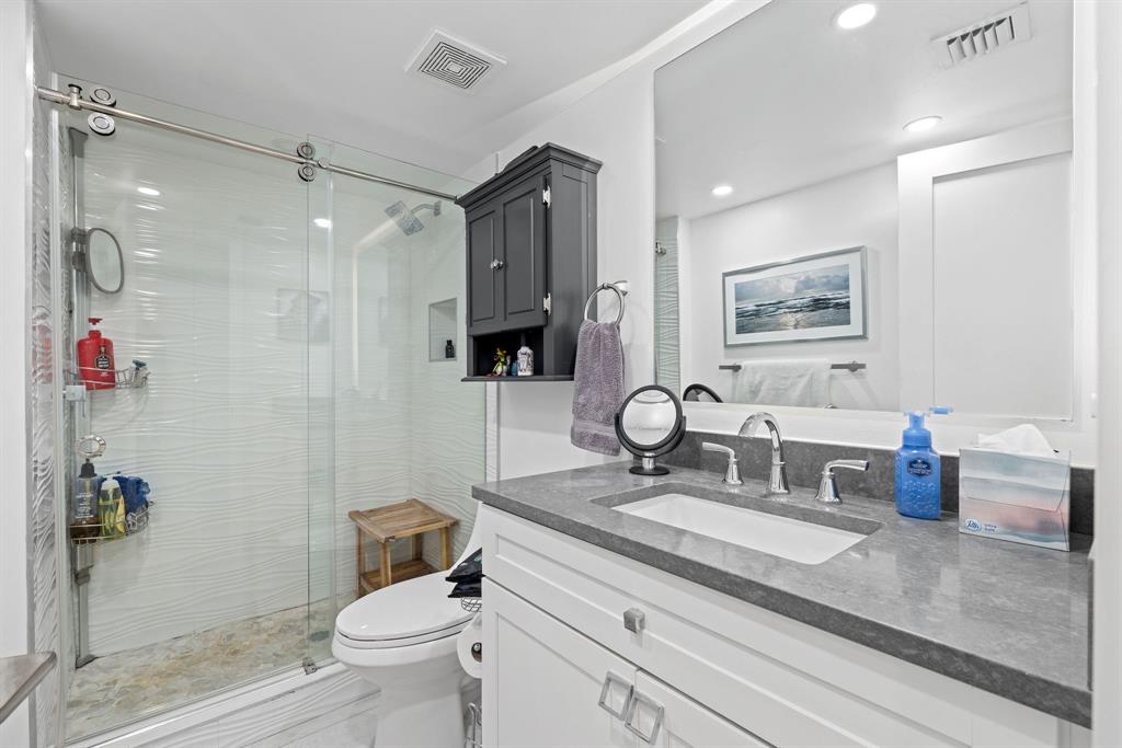 3100 Northeast 49th Street, Unit 206 Fort Lauderdale, FL 33308 - Photo 23 of 39 a bathroom with a granite countertop sink toilet and shower