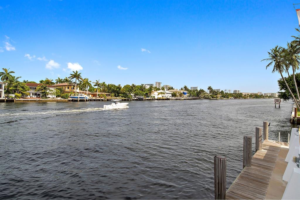 3100 Northeast 49th Street, Unit 206 Fort Lauderdale, FL 33308 - Photo 32 of 39 a view of a terrace with lawn chairs and iron fence