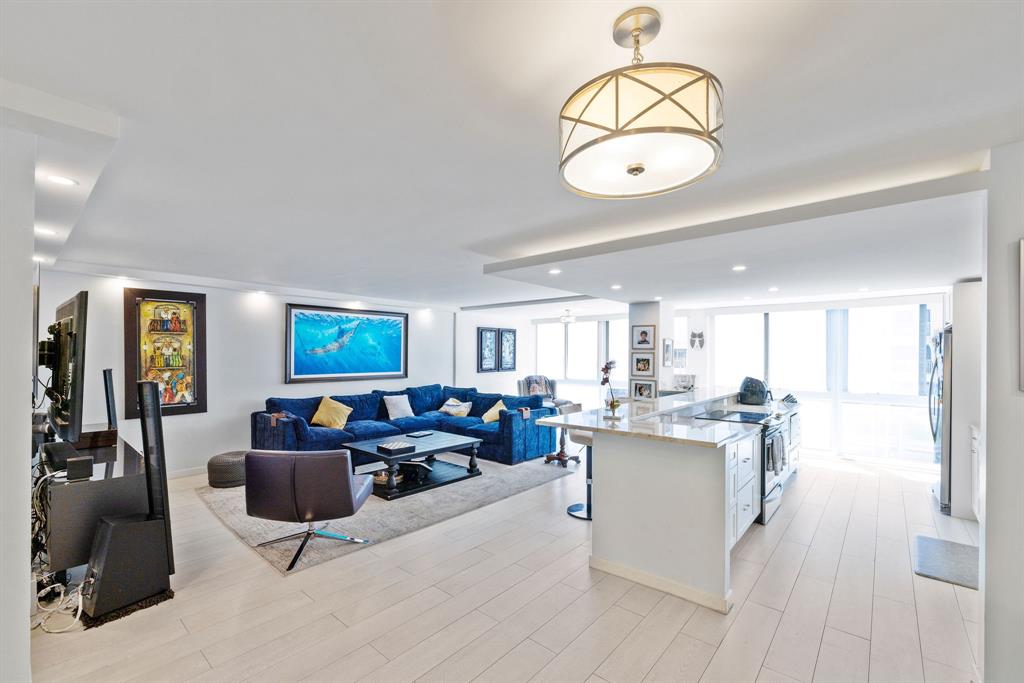 3100 Northeast 49th Street, Unit 206 Fort Lauderdale, FL 33308 - Photo 4 of 39 a living room with kitchen island furniture and a large window