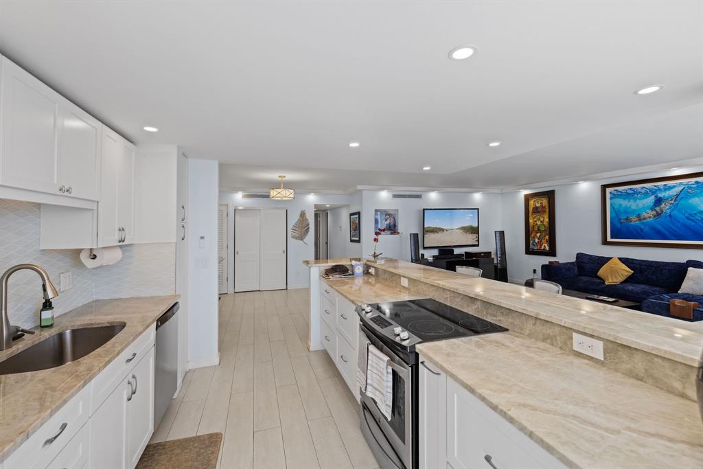 3100 Northeast 49th Street, Unit 206 Fort Lauderdale, FL 33308 - Photo 9 of 39 a kitchen with stainless steel appliances a sink stove and cabinets