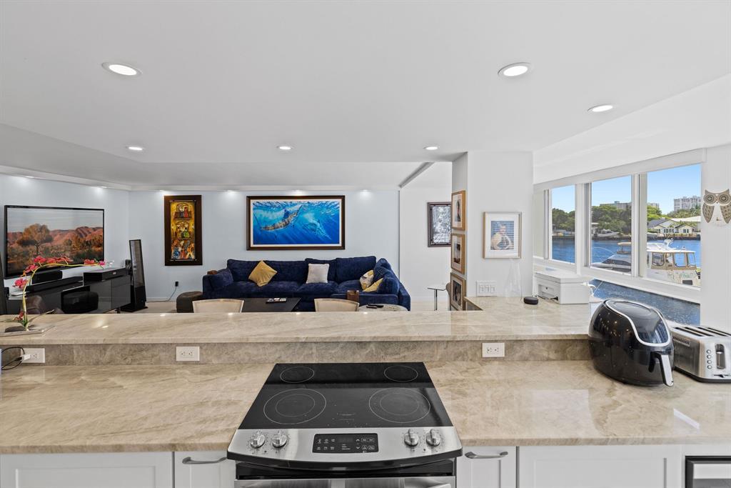 3100 Northeast 49th Street, Unit 206 Fort Lauderdale, FL 33308 - Photo 10 of 39 a living room with furniture and a flat screen tv