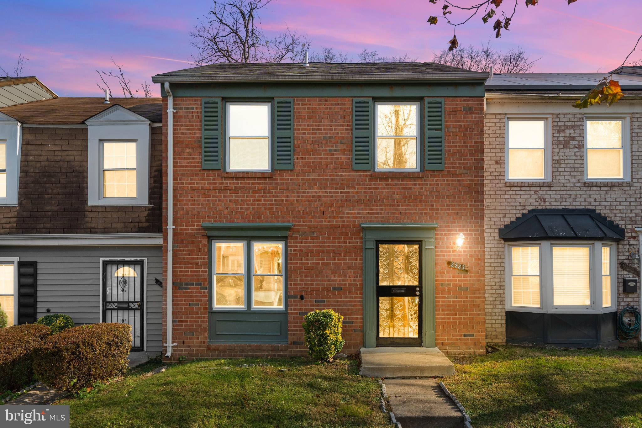 Charming brick home at twilight glow.