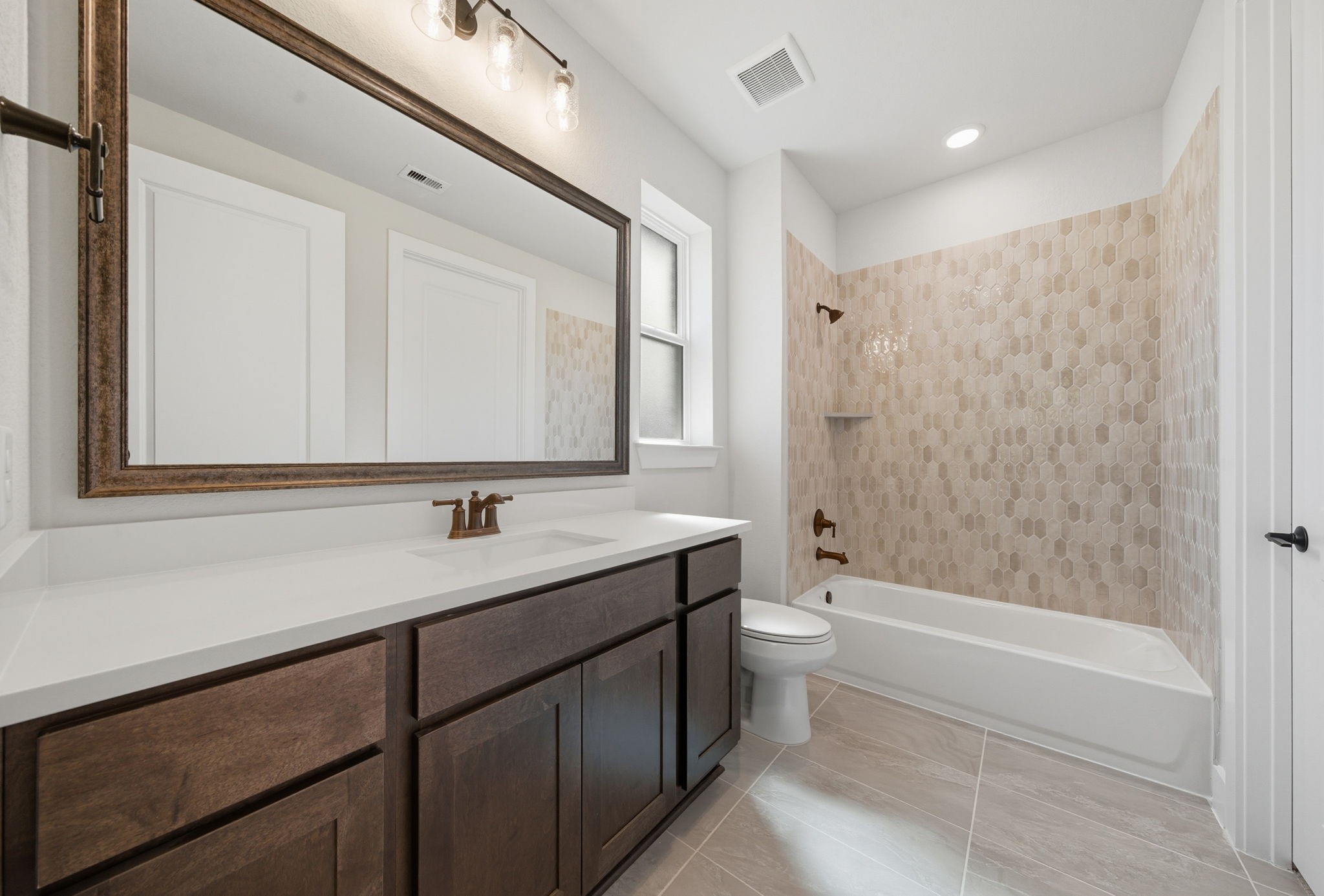 10041 Larkin Cove Willis, TX 77318 - Photo 21 of 48 a bathroom with a tub sink toilet and a mirror