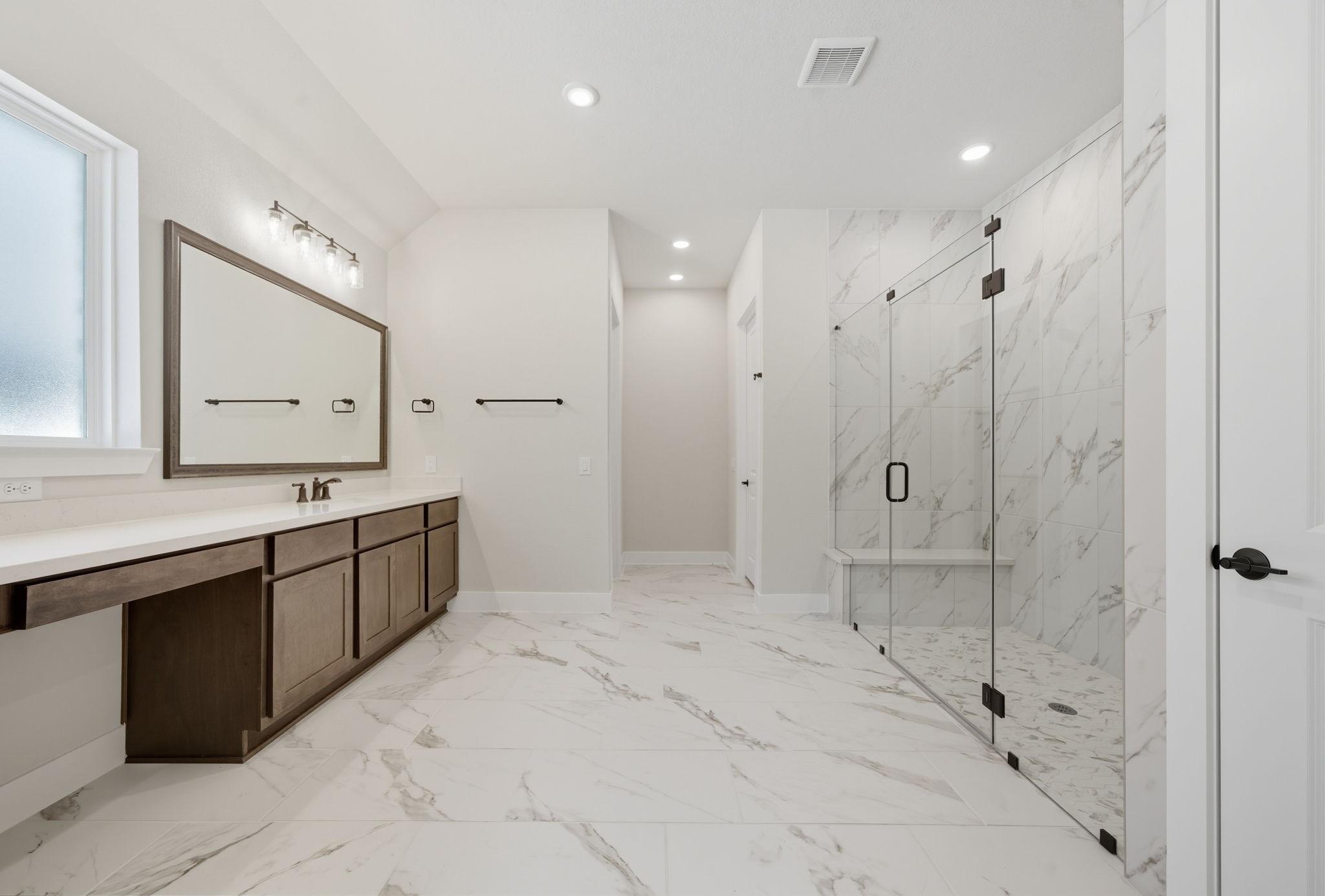 10041 Larkin Cove Willis, TX 77318 - Photo 27 of 48 a spacious bathroom with a shower sink and mirror