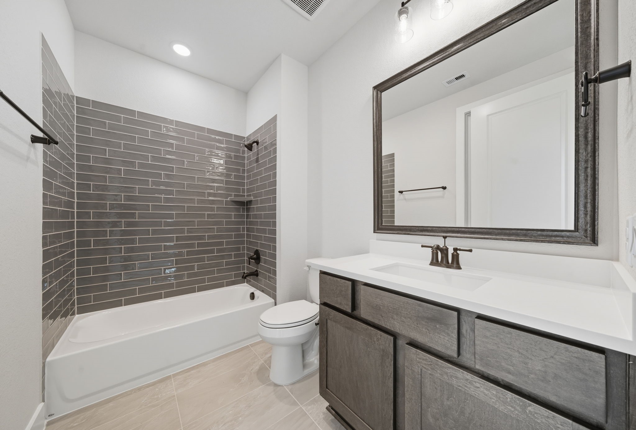 10041 Larkin Cove Willis, TX 77318 - Photo 29 of 48 a bathroom with a bathtub shower sink vanity and toilet
