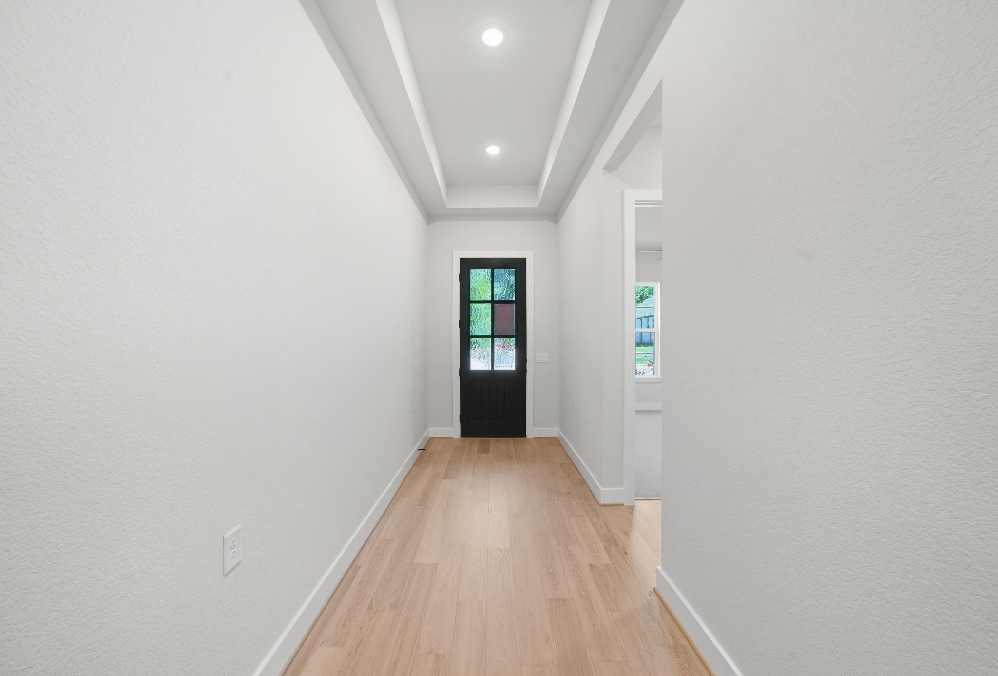 10041 Larkin Cove Willis, TX 77318 - Photo 4 of 48 a view of a hallway with wooden floor