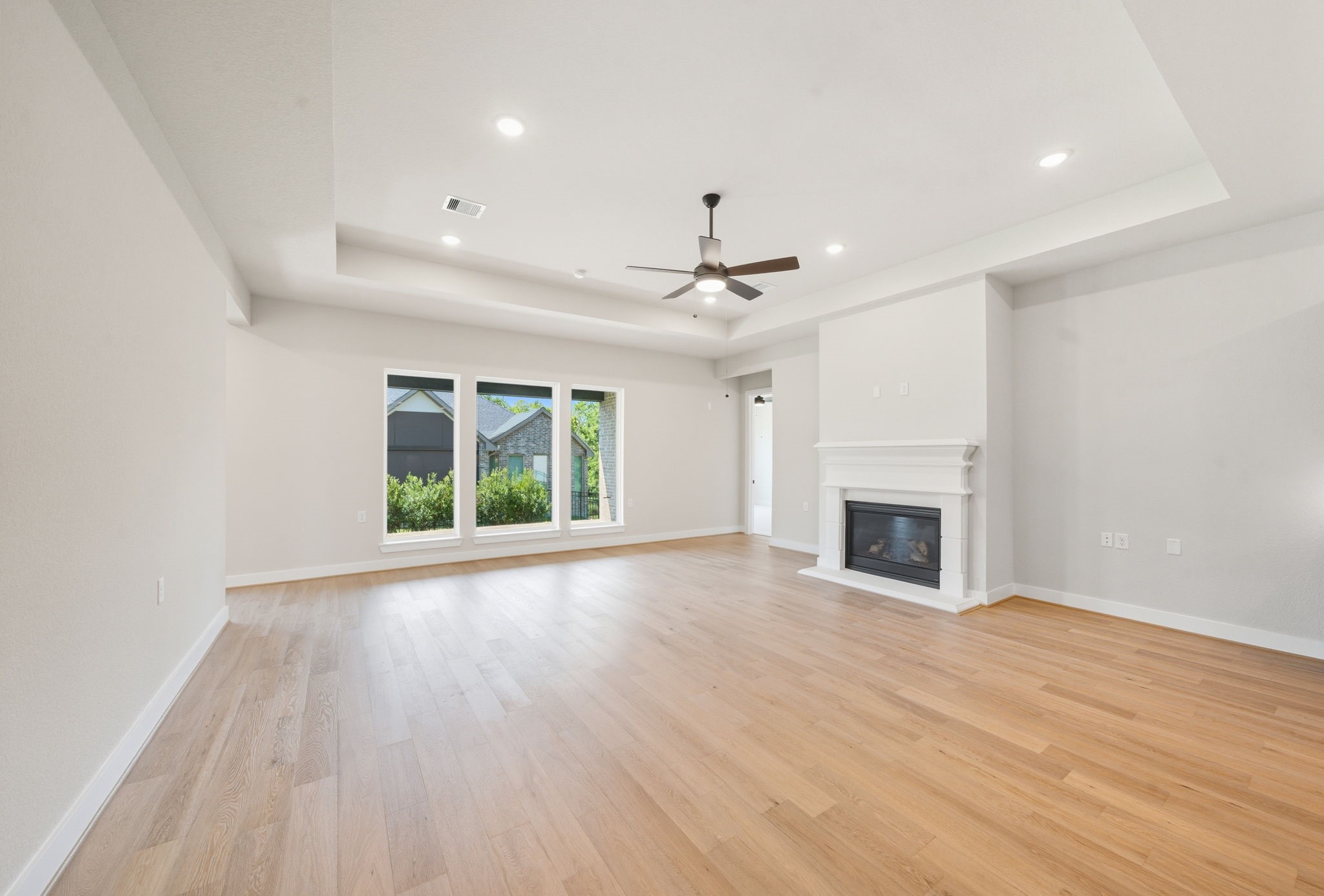 10041 Larkin Cove Willis, TX 77318 - Photo 7 of 48 a view of an empty room with wooden floor fireplace and a window