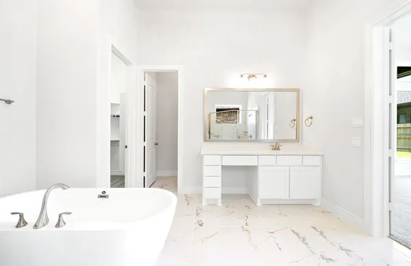 a bathroom with a bathtub sink and mirror