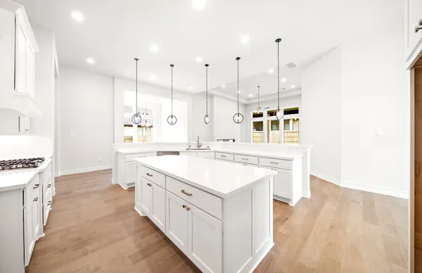 a kitchen with stainless steel appliances kitchen island granite countertop a stove a sink and a refrigerator