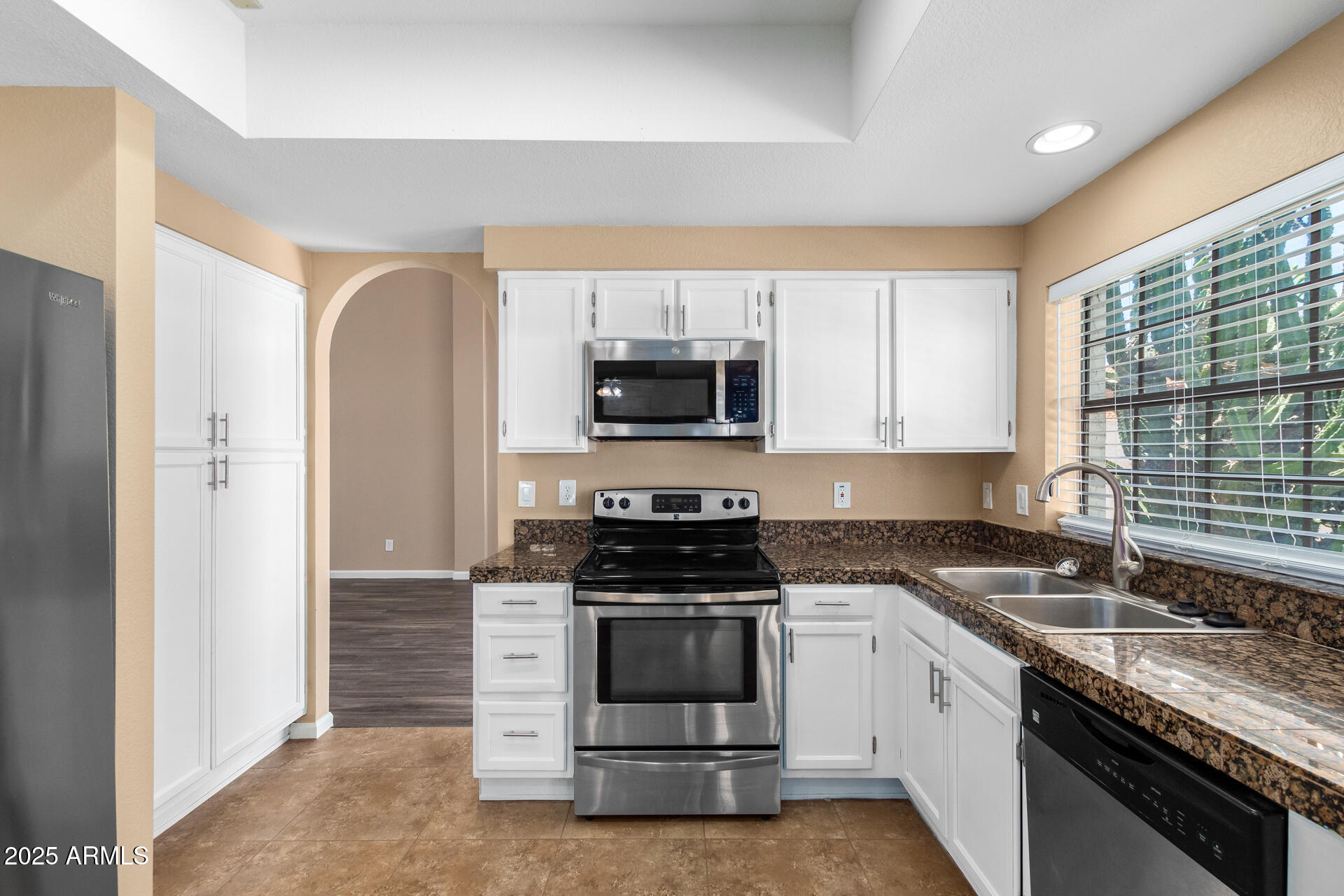 6121 East Saddleback Street Mesa, AZ 85215 - Photo 11 of 36 a kitchen with sink a microwave and cabinets