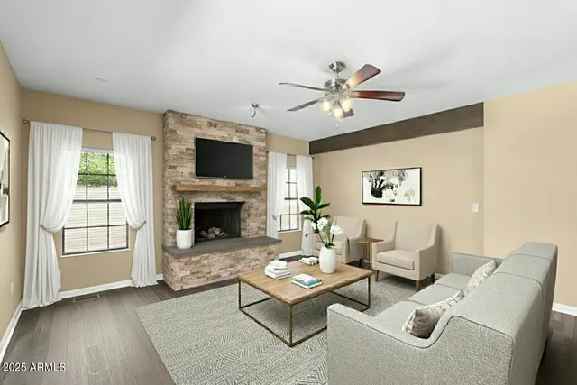 a view of a livingroom with wooden floor and a ceiling fan