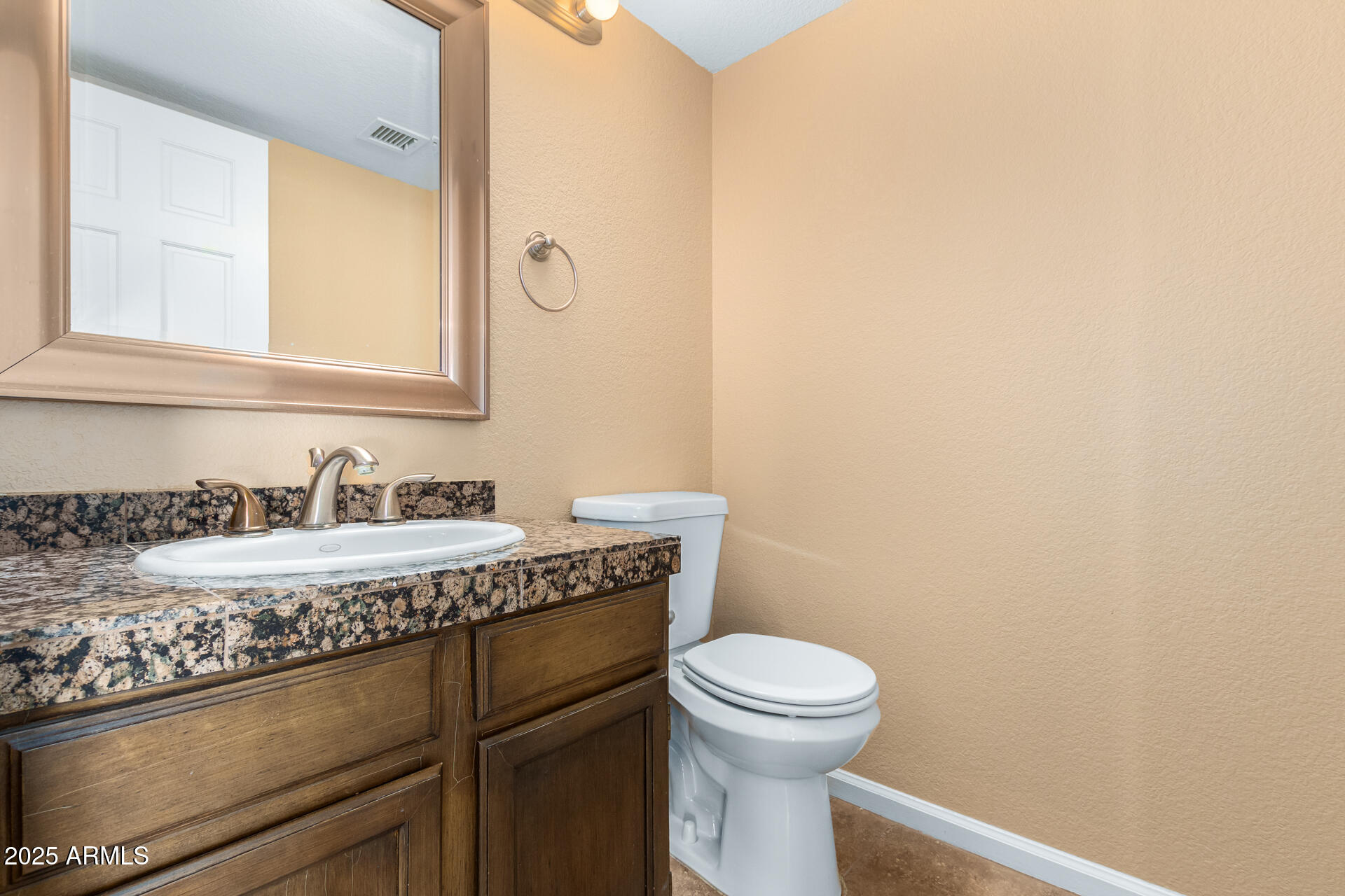 6121 East Saddleback Street Mesa, AZ 85215 - Photo 16 of 36 a bathroom with a granite countertop sink a toilet and a mirror