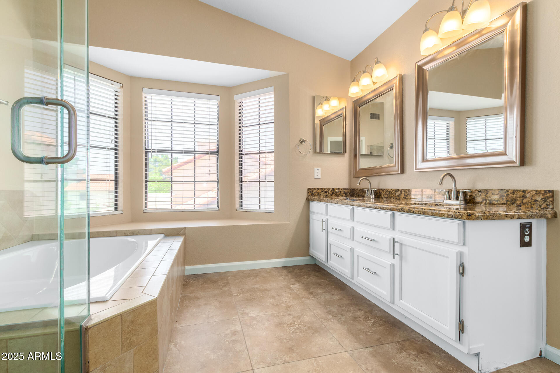 6121 East Saddleback Street Mesa, AZ 85215 - Photo 20 of 36 a spacious bathroom with a granite countertop tub sink and mirror