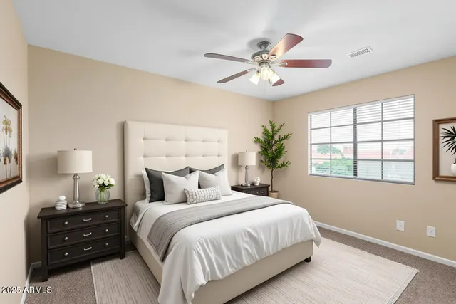 an empty room with a window and a ceiling fan