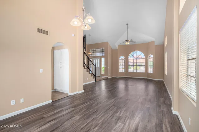 a view of an entryway with wooden floor fan and a window