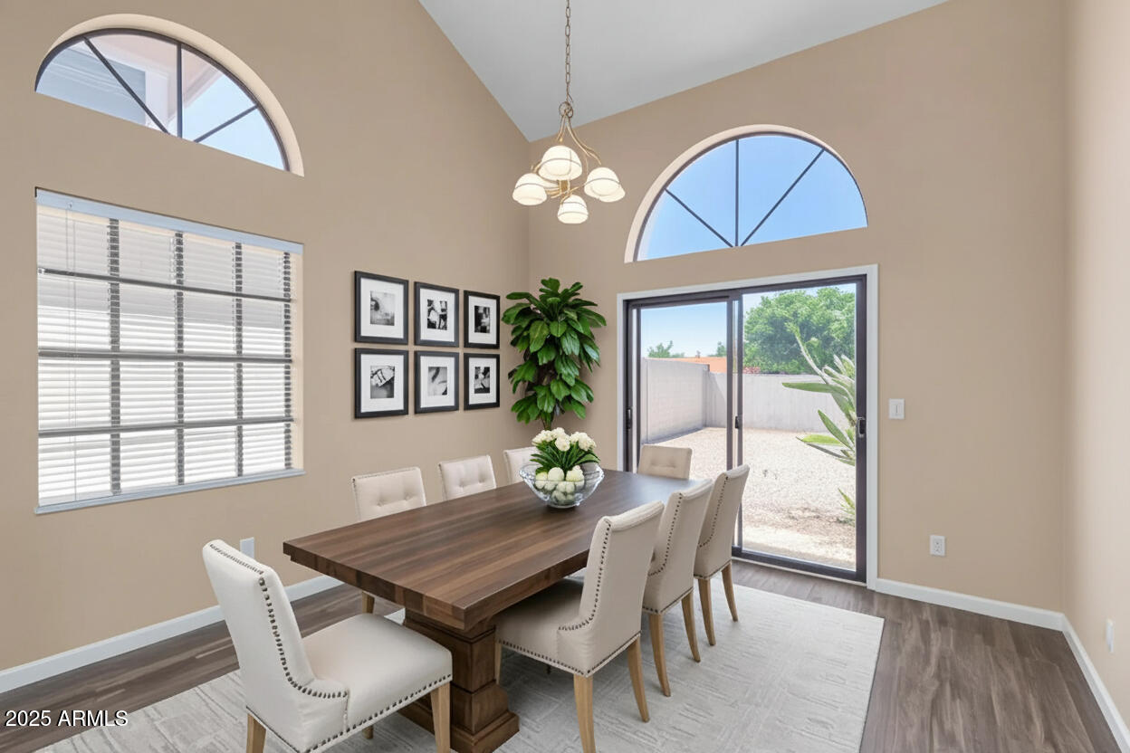 6121 East Saddleback Street Mesa, AZ 85215 - Photo 7 of 36 a view of a dining room with furniture window and wooden floor