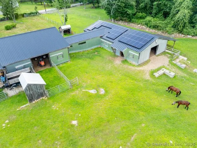 a view of a chairs in a yard with wooden fence