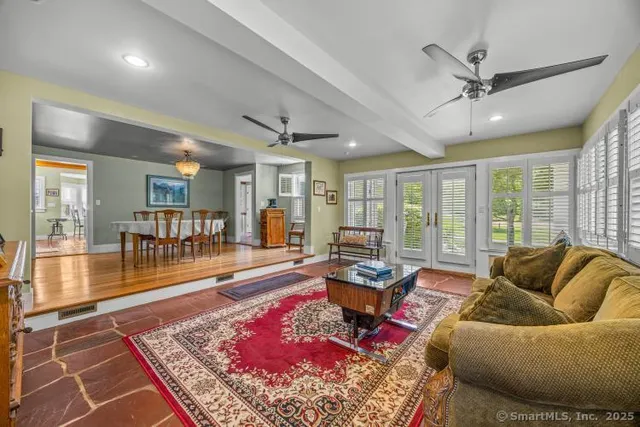 a living room with furniture rug and wooden floor