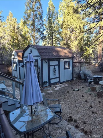 a front view of a house with a yard fire pit table and chairs
