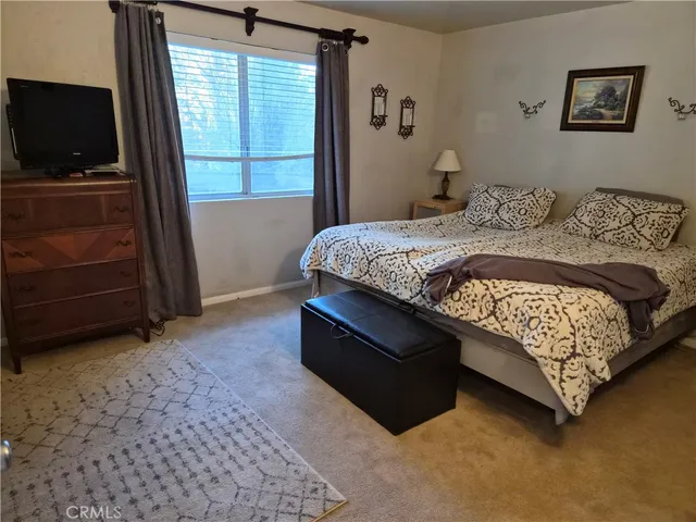 a bedroom with a bed and a television