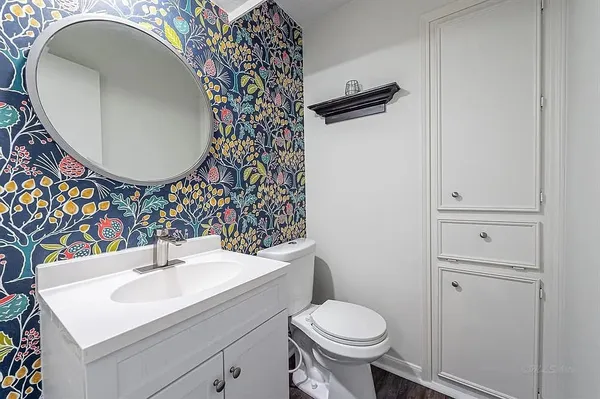 a bathroom with a sink toilet and mirror