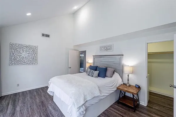 a bedroom with a bed and a night stand
