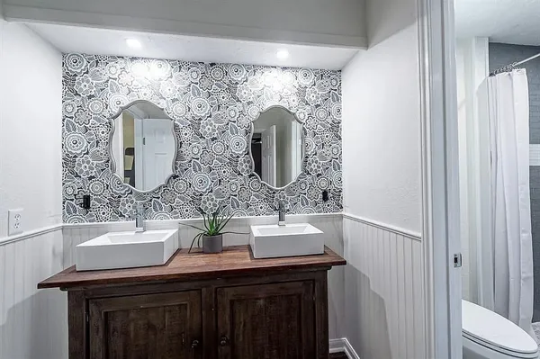 a bathroom with a double vanity sink and a mirror