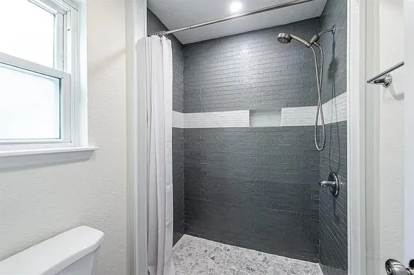 a bathroom with a shower and toilet