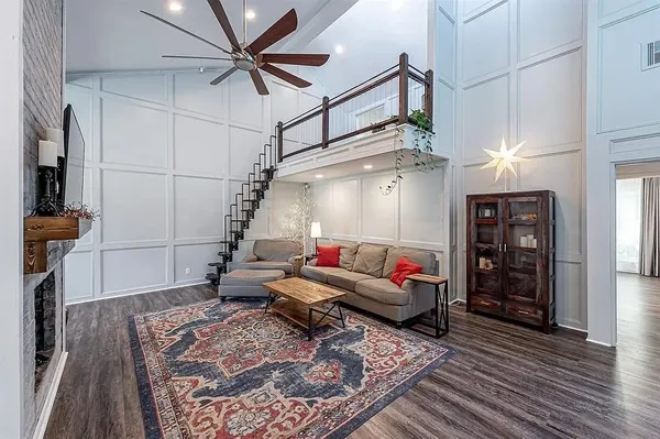 a living room with furniture and wooden floor