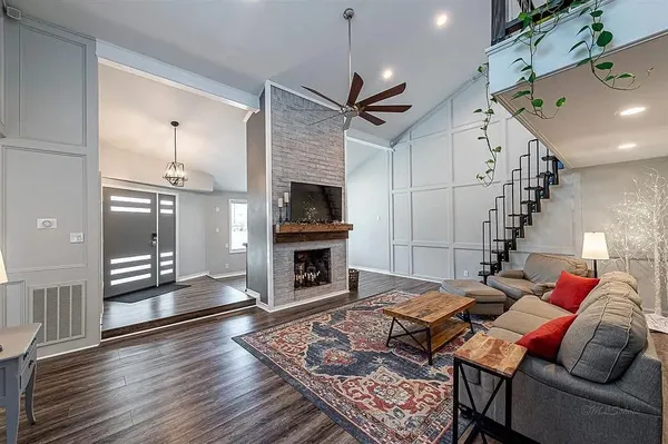 a living room with furniture and a fireplace