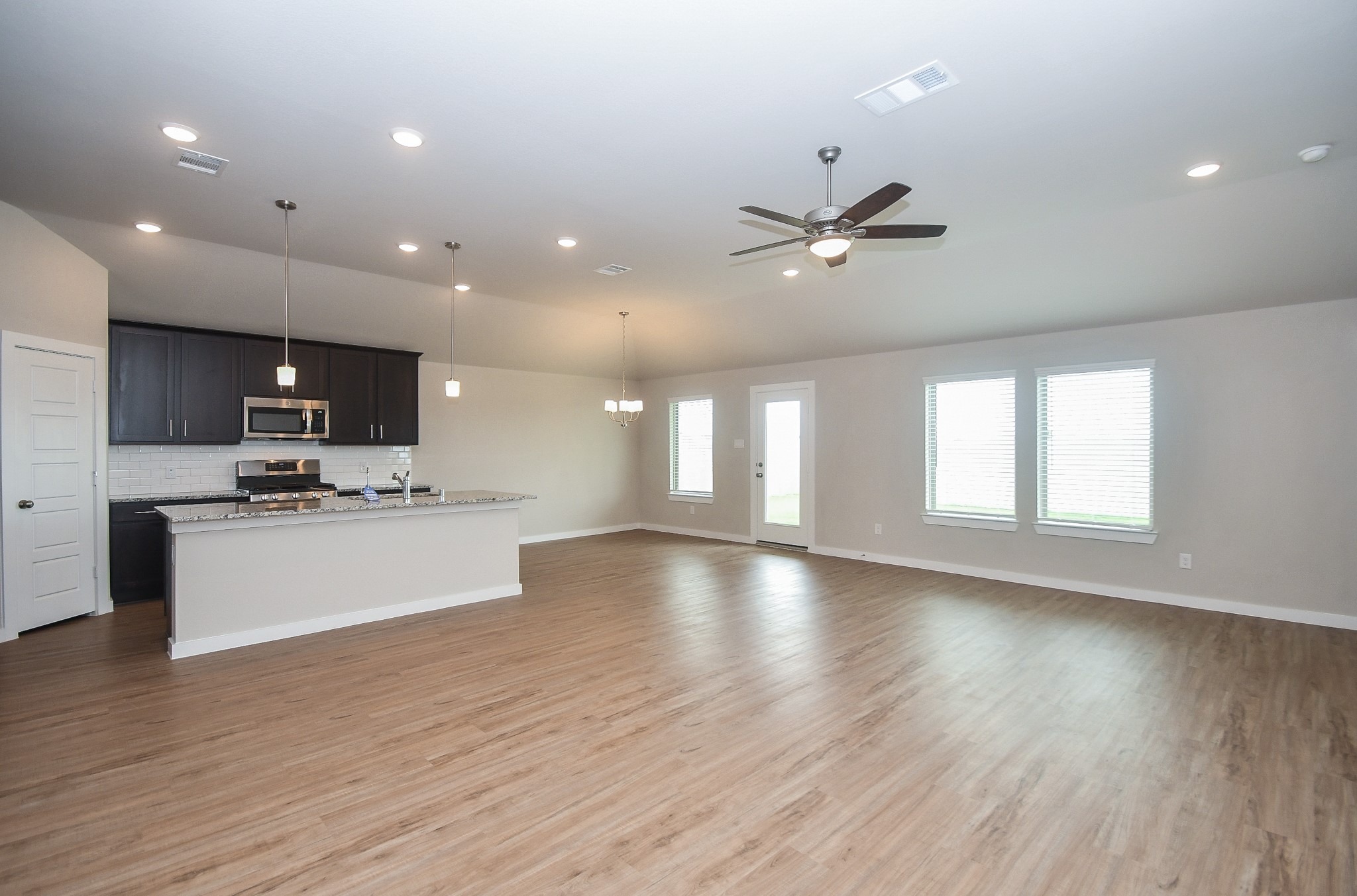 2007 Live Springs Way Rosenberg, TX 77471 - Photo 6 of 25 View of the kitchen, living area, and breakfast nook.